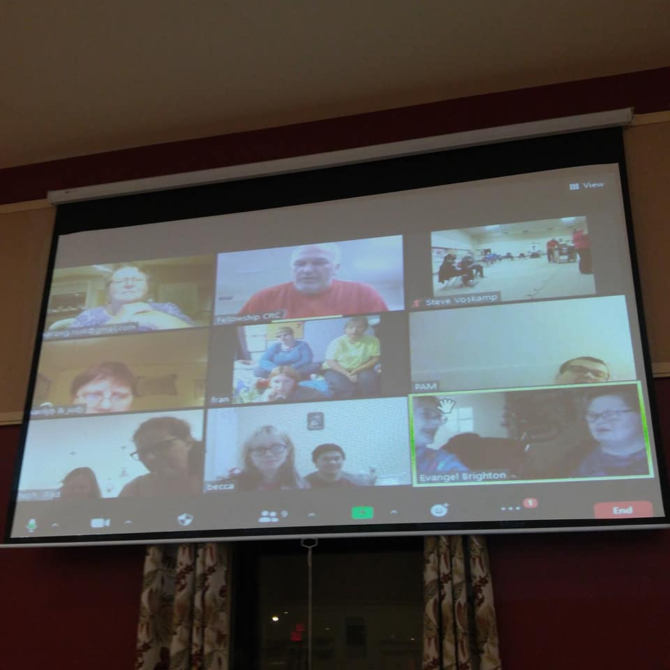 a screen with several faces on it, as in a Zoom meeting